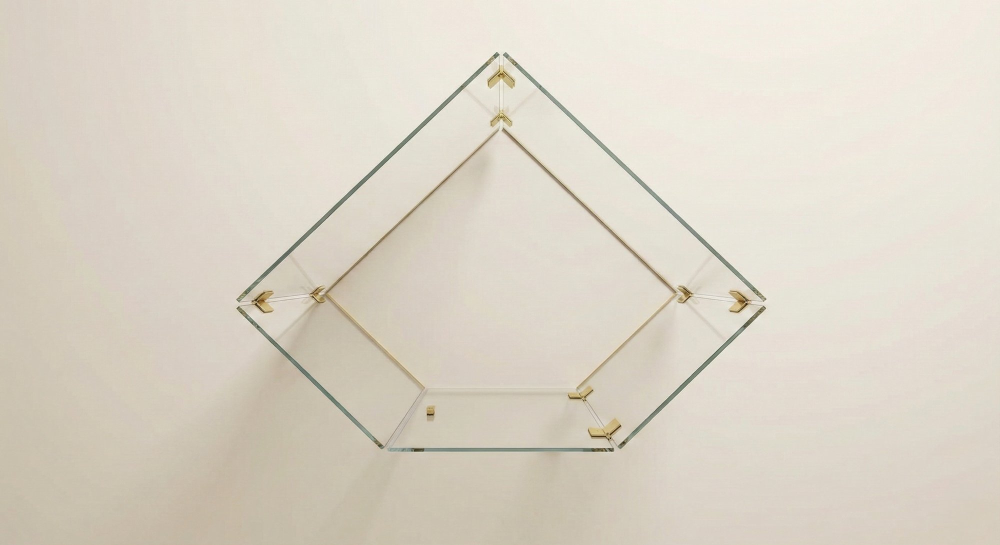 Neo-angle frameless glass enclosure overhead view with brass clamps