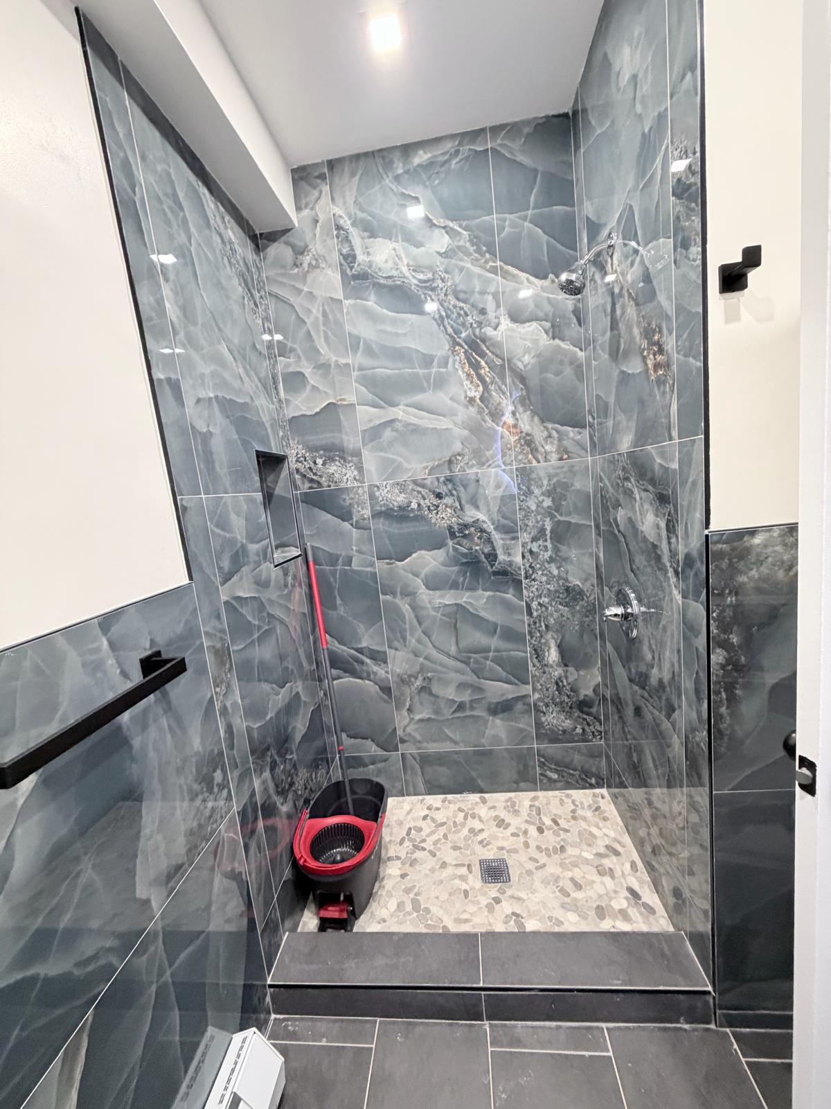 Custom frameless shower enclosure installed by MetroGlass Pro NYC