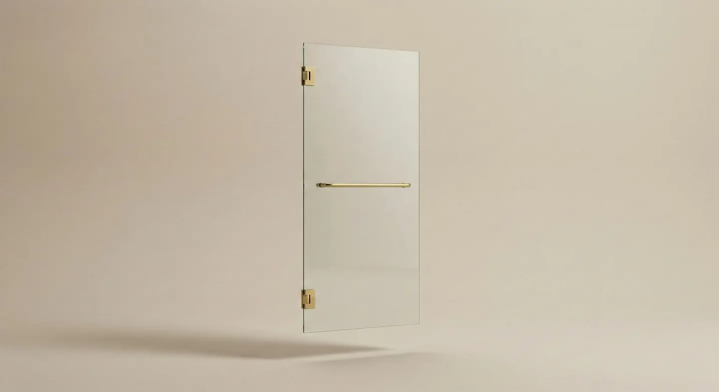 Single swing frameless shower door with satin brass hinges