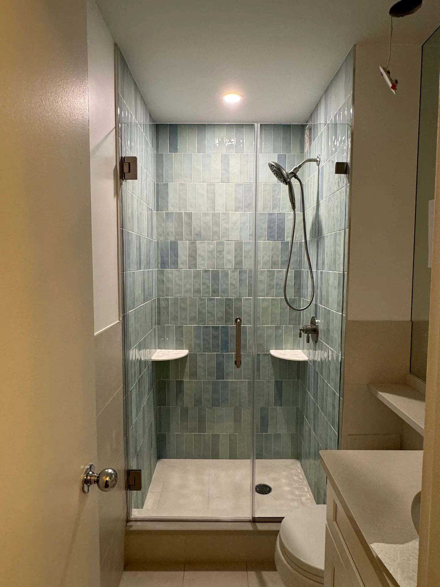 Sliding bypass shower doors above a bathtub